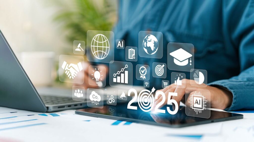 Person using a laptop with floating digital icons and "2025" text, representing technology and future concepts.