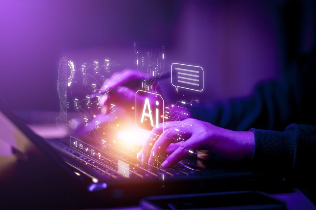 Hands typing on a laptop keyboard with digital AI graphics overlay, featuring circuit patterns and a chat bubble.